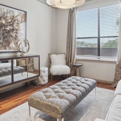 a living room with a couch, media center and a chair