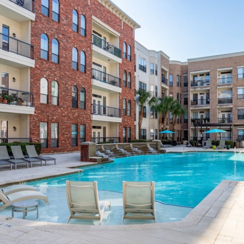Resort-style swimming pool with lounge seating