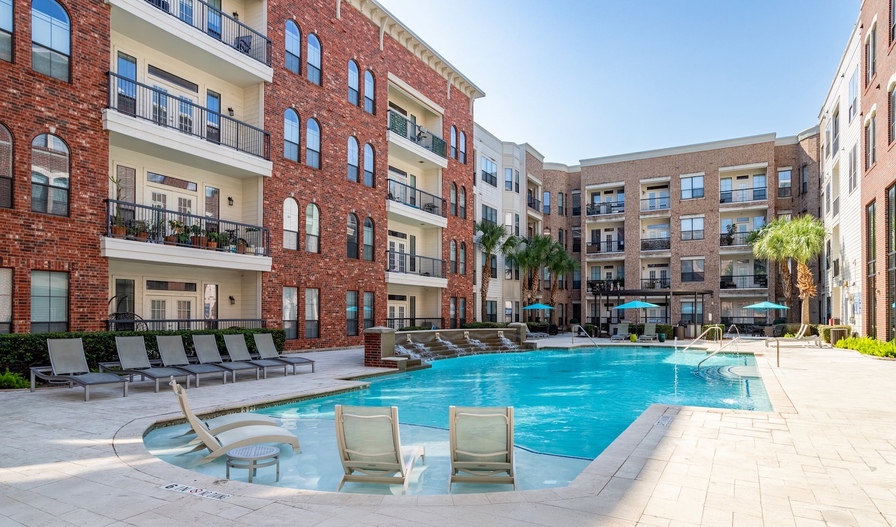 Resort-style swimming pool with lounge seating